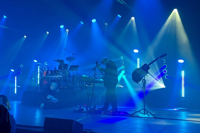 Devin Townsend kneels before Mike Keneally